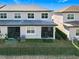 Townhome community featuring screened patios and grassy yards at 8512 Magnificent Ln, Groveland, FL 34736