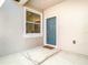 Inviting front entrance with a teal door and side window at 8512 Magnificent Ln, Groveland, FL 34736