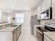 Sleek kitchen featuring granite countertops and stainless steel appliances at 8512 Magnificent Ln, Groveland, FL 34736