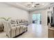 Spacious living room featuring tile floors and sliding glass doors to patio at 8512 Magnificent Ln, Groveland, FL 34736