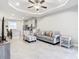 Open concept living room with kitchen view and tile flooring at 8512 Magnificent Ln, Groveland, FL 34736