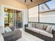 Spacious screened porch with wicker furniture at 8512 Magnificent Ln, Groveland, FL 34736
