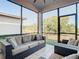 Relaxing screened porch with wicker furniture at 8512 Magnificent Ln, Groveland, FL 34736