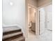 Carpeted stairs leading to the second floor with a powder room nearby at 8512 Magnificent Ln, Groveland, FL 34736