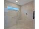 Large walk-in shower with glass enclosure and neutral tile at 1110 Ebling Loop, The Villages, FL 32163