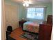 Cozy bedroom with double doors and a dresser at 117 Hibiscus Way, Leesburg, FL 34748