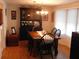 Bright dining room with wood table and hutch, hardwood floors at 117 Hibiscus Way, Leesburg, FL 34748