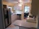 Eat-in kitchen with stainless steel appliances and light wood cabinets at 117 Hibiscus Way, Leesburg, FL 34748