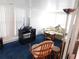 Bright living room with blue carpet, comfy seating, and lots of natural light at 117 Hibiscus Way, Leesburg, FL 34748