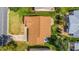 Single-story home with brown roof and landscaped yard, seen from above at 1233 Carvello Dr, The Villages, FL 32162
