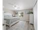 Spacious primary bedroom with king-size bed and updated flooring at 1233 Carvello Dr, The Villages, FL 32162
