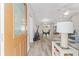 Bright and spacious entryway with wood-look floors, leading to living area at 1233 Carvello Dr, The Villages, FL 32162