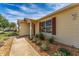 House exterior showcasing walkway, landscaping, and light-beige siding at 1233 Carvello Dr, The Villages, FL 32162