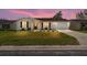 Charming one-story house with a well-manicured lawn and attached garage at 1233 Carvello Dr, The Villages, FL 32162