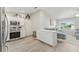 Kitchen boasts white cabinets, stainless steel appliances, and an island at 1233 Carvello Dr, The Villages, FL 32162