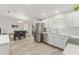 Modern kitchen with white cabinets, stainless steel appliances, and tile backsplash at 1233 Carvello Dr, The Villages, FL 32162