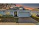 One-story home with gray siding, brick driveway, and two-car garage at 1270 Stratton Ave, Groveland, FL 34736