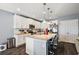 White kitchen cabinets, granite island, and stainless steel appliances at 1270 Stratton Ave, Groveland, FL 34736