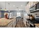 Modern kitchen with white cabinets, granite countertops, and stainless steel appliances at 1270 Stratton Ave, Groveland, FL 34736