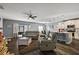 Open-concept living space with gray walls and a modern kitchen at 1270 Stratton Ave, Groveland, FL 34736