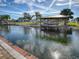 Waterfront property with a covered boat dock and lush landscaping at 13314 Orange Blossom St, Astatula, FL 34705