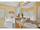 Bathroom with soaking tub and double vanity at 151 Rubino Dr, Davenport, FL 33837