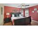 Bedroom with a queen-size bed and red accent wall at 151 Rubino Dr, Davenport, FL 33837