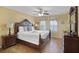 King size bed, dresser and TV in a bedroom with wood floors at 151 Rubino Dr, Davenport, FL 33837