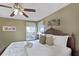 Main bedroom with a king-size bed and relaxing lake view at 151 Rubino Dr, Davenport, FL 33837