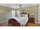 Bedroom with king-size bed, ceiling fan, and wood floors at 151 Rubino Dr, Davenport, FL 33837