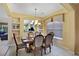 Elegant dining room with a wood table, six chairs, and built-in shelving at 151 Rubino Dr, Davenport, FL 33837