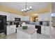 Bright kitchen with white cabinets, a large island, and stainless steel appliances at 151 Rubino Dr, Davenport, FL 33837