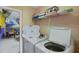 Laundry room with washer, dryer, and shelving for linens at 151 Rubino Dr, Davenport, FL 33837