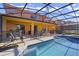 Relaxing pool area with screened enclosure and patio furniture at 151 Rubino Dr, Davenport, FL 33837