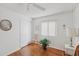 Cozy bedroom with ceiling fan, chair, small table and closet at 1511 New Abbey Ave, Leesburg, FL 34788