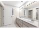 Bathroom with a double vanity and large mirror at 17329 Se 115Th Terrace Rd, Summerfield, FL 34491