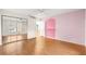 Bright bedroom with mirrored closet doors and hardwood floors at 17329 Se 115Th Terrace Rd, Summerfield, FL 34491