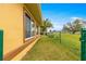 Landscaped side yard with chain link fence and grassy area at 17329 Se 115Th Terrace Rd, Summerfield, FL 34491