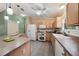 Well-equipped kitchen featuring wood cabinets and tile floors at 17648 Se 93Rd Butler Ct, The Villages, FL 32162