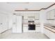 Efficient kitchen featuring white cabinetry and a built-in microwave at 17754 Se 95Th Cir, Summerfield, FL 34491