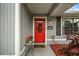 Red front door with wreath, gray siding, and landscaping at 2183 Croat St, Mount Dora, FL 32757