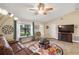 Living room with fireplace, TV, and large windows at 2183 Croat St, Mount Dora, FL 32757