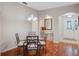 Bright dining area with hardwood floors, glass-top table, and entryway view at 22250 Draw Bridge Dr, Leesburg, FL 34748