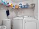 Laundry room with washer, dryer, and storage shelves at 22250 Draw Bridge Dr, Leesburg, FL 34748