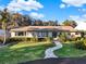 Single-story house with a landscaped yard and a paved walkway at 2301 Lakeshore Dr, Mount Dora, FL 32757