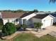 Single-story house with brown roof and landscaped yard at 2361 E Gaffney Ave, The Villages, FL 32162