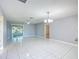 Spacious living room with tile floors and sliding glass doors at 2361 E Gaffney Ave, The Villages, FL 32162