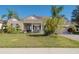 House front view with lush landscaping and driveway at 2584 Squaw Crk, Clermont, FL 34711