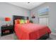 Bright bedroom with coral bedding and a dark wood frame bed at 27214 Stoney Brook Dr, Leesburg, FL 34748