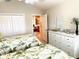 Bedroom featuring two twin beds, white dresser, and ensuite bathroom access at 2850 Apache Ct, The Villages, FL 32163